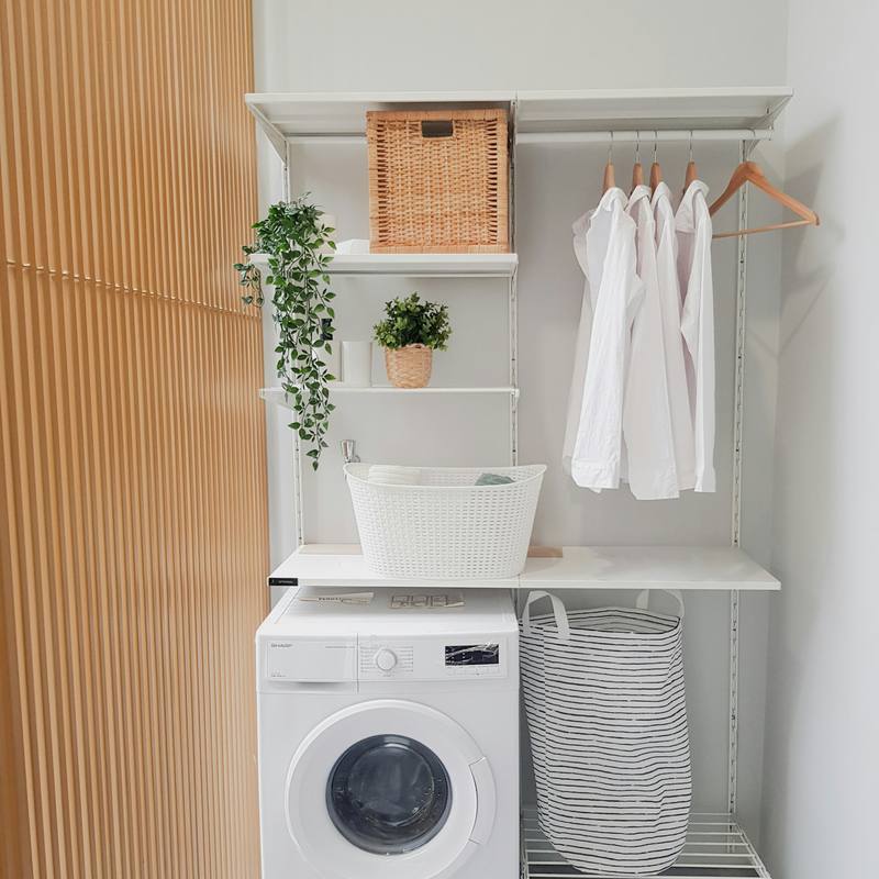 Tidy laundry corner with a front-load washing machine