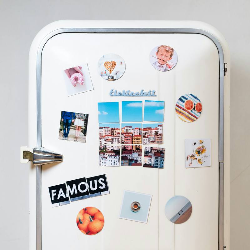 Family refrigerator door covered in photos and magnets