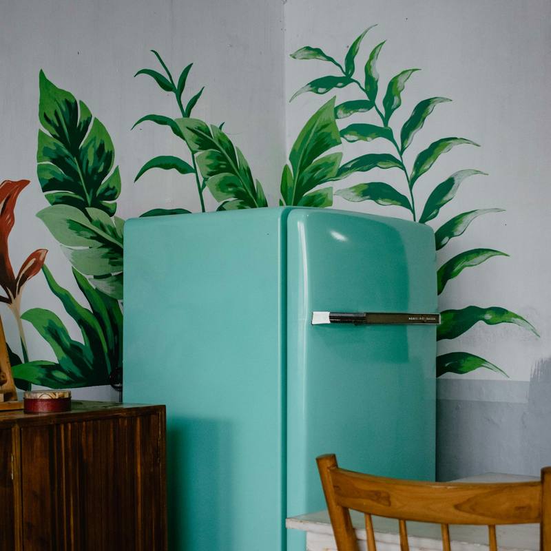 Mint green retro-style refrigerator in a bright room